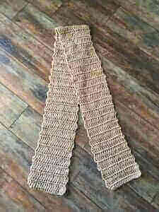 A simple crochet scarf in light brown yarn.