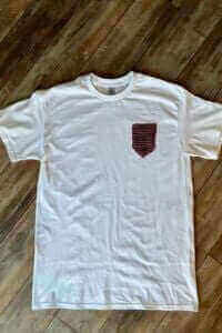 A white t-shirt with a crocheted pocket attached.
